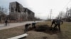 UKRAINE - People dig graves for victims killed in Mariupol, March 20, 2022.